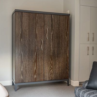 Tall custom cabinet with dark wood-grain doors and slim metal pulls